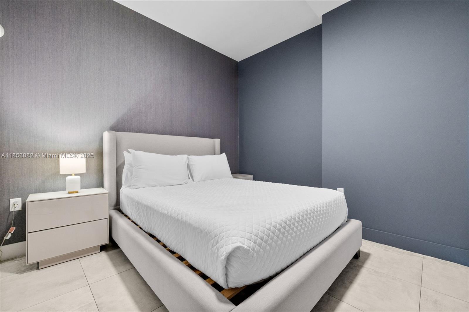 239 Southwest 9th Street, Unit 2303 Miami, FL 33130 - Photo 24 of 75 a bedroom with a bed and a night stand