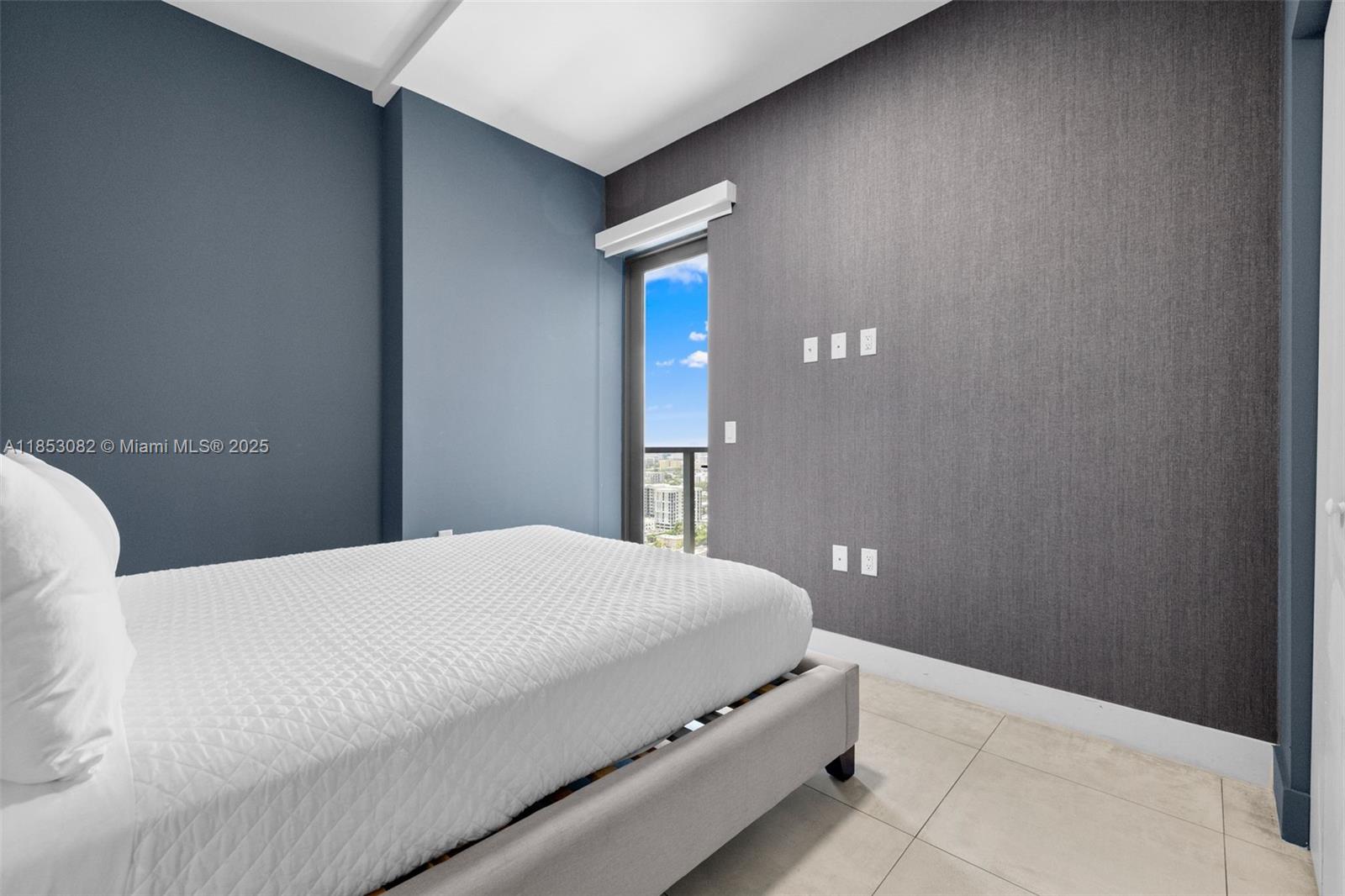 239 Southwest 9th Street, Unit 2303 Miami, FL 33130 - Photo 25 of 75 a bedroom with a bed and a lamp on the dresser