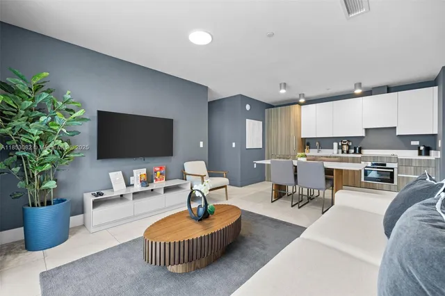 a living room with furniture and a potted plant