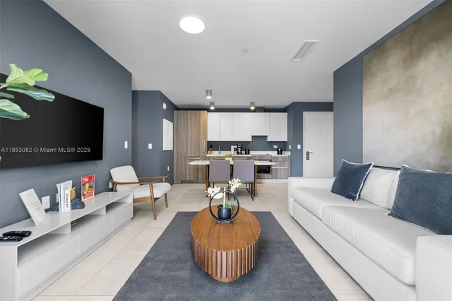 a living room with furniture potted plant and a window