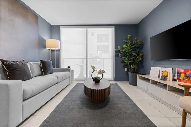 a kitchen with kitchen island granite countertop a sink cabinets and stainless steel appliances