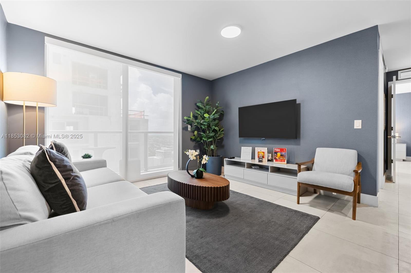 239 Southwest 9th Street, Unit 2303 Miami, FL 33130 - Photo 34 of 75 a living room with furniture and a flat screen tv