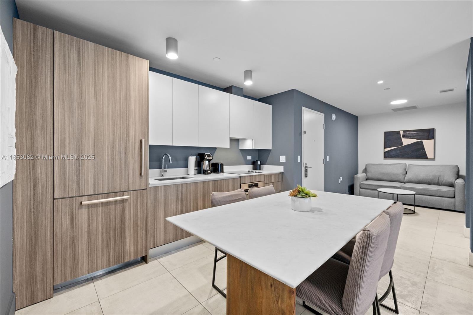 239 Southwest 9th Street, Unit 2303 Miami, FL 33130 - Photo 35 of 75 a kitchen with stainless steel appliances kitchen island granite countertop a refrigerator a stove a sink dishwasher with a dining table and chairs