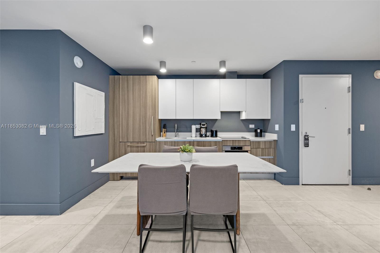 239 Southwest 9th Street, Unit 2303 Miami, FL 33130 - Photo 37 of 75 a large kitchen with a table and chairs in it