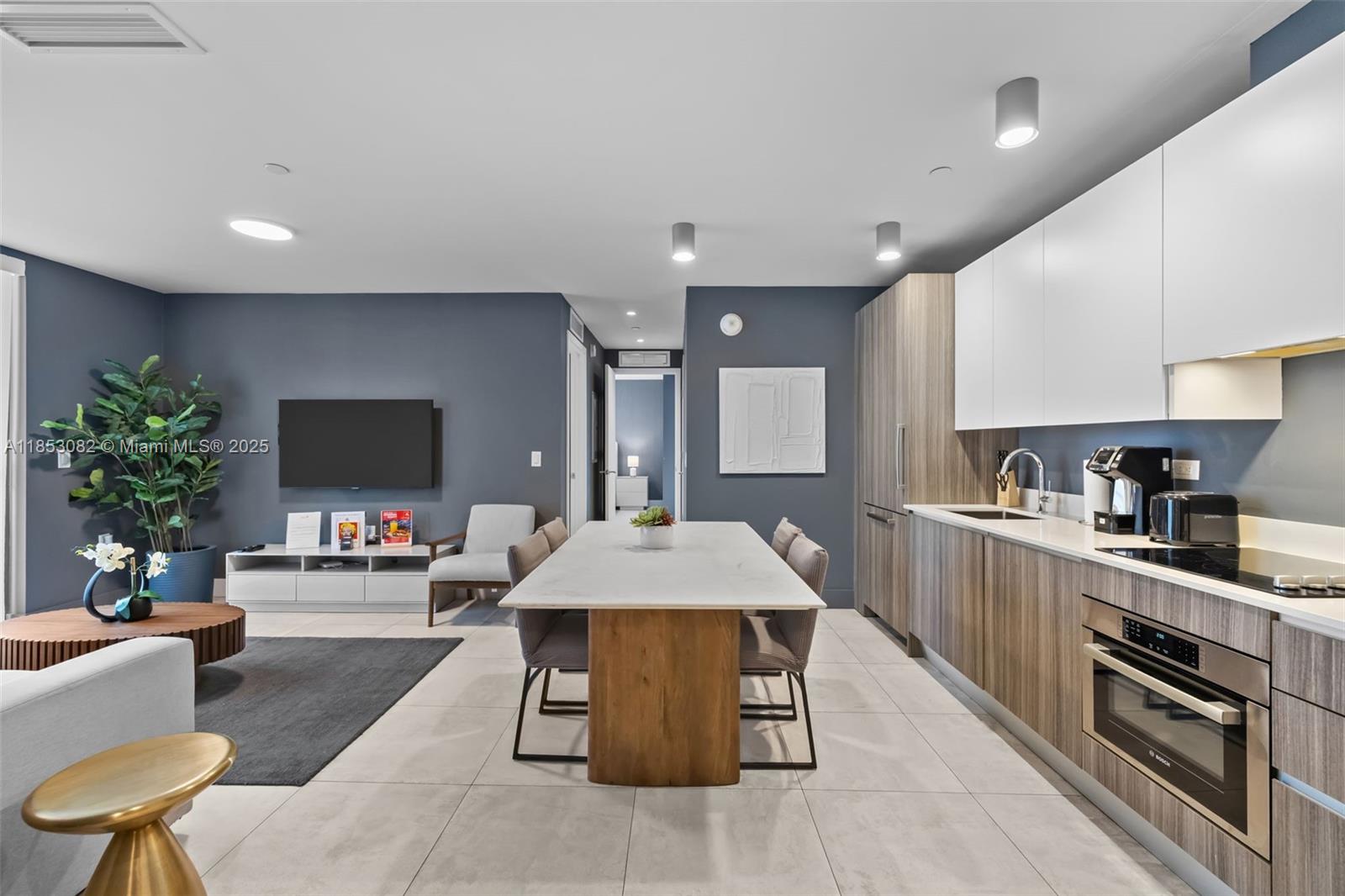 239 Southwest 9th Street, Unit 2303 Miami, FL 33130 - Photo 41 of 75 a large kitchen with stainless steel appliances a stove a sink dishwasher and a refrigerator with wooden floor