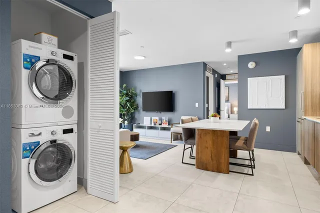 a kitchen with stainless steel appliances granite countertop a sink window and cabinets