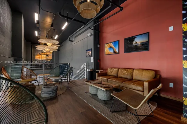 a view of a livingroom with furniture and workspace