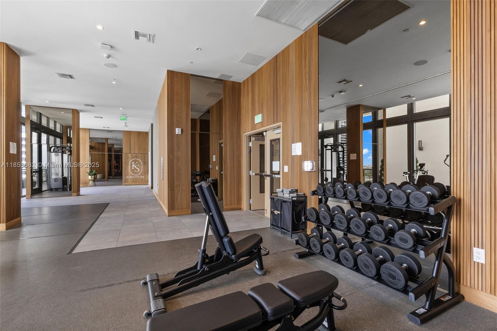 239 Southwest 9th Street, Unit 2303 Miami, FL 33130 - Photo 64 of 75 a room with gym equipment and large mirror