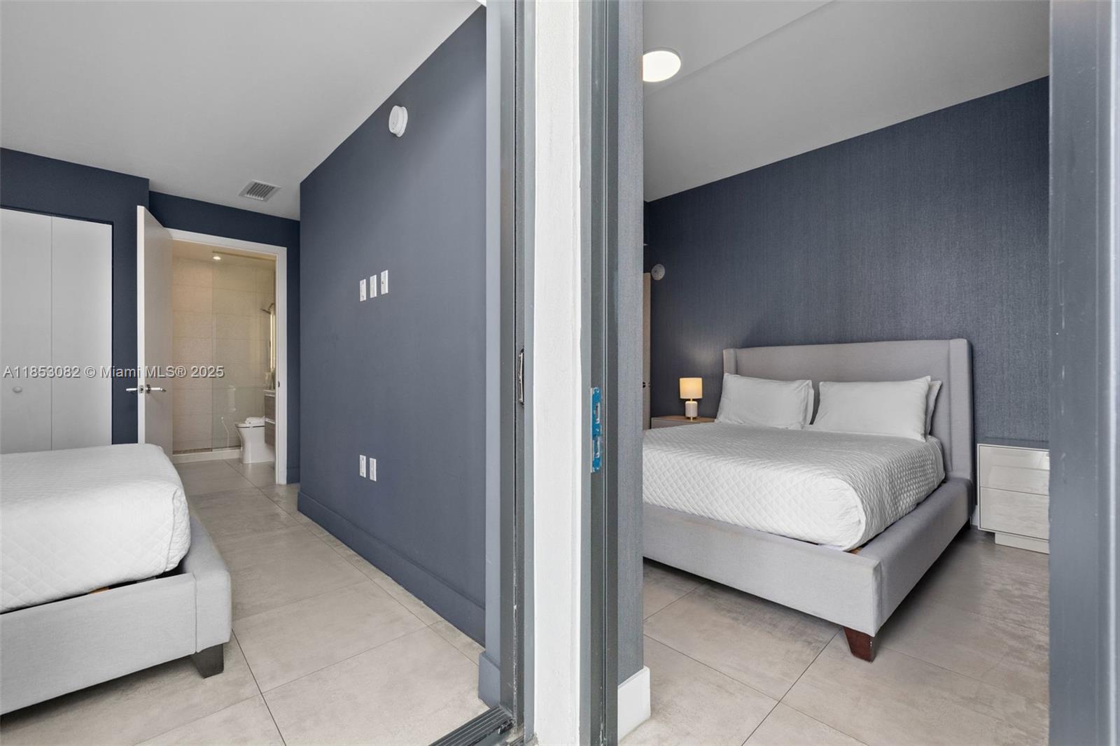 239 Southwest 9th Street, Unit 2303 Miami, FL 33130 - Photo 10 of 75 a bedroom with a bed and lamp