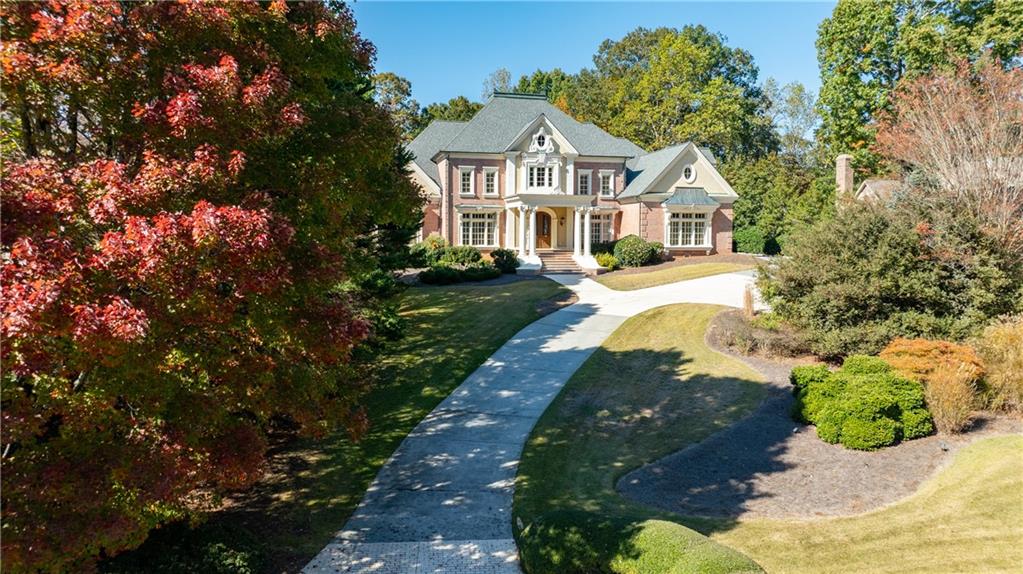 9390 Colonnade Trail Alpharetta, GA 30022 - Photo 102 of 122 a front view of a house with a yard and green space