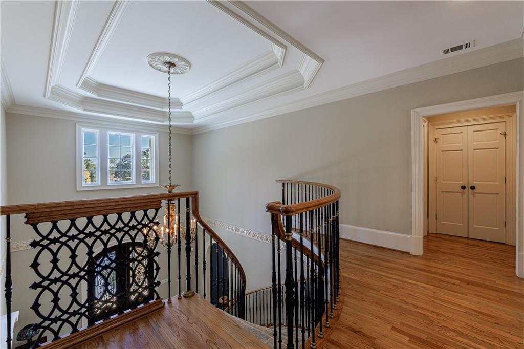 9390 Colonnade Trail Alpharetta, GA 30022 - Photo 47 of 122 a view of a hallway with wooden floor and staircase