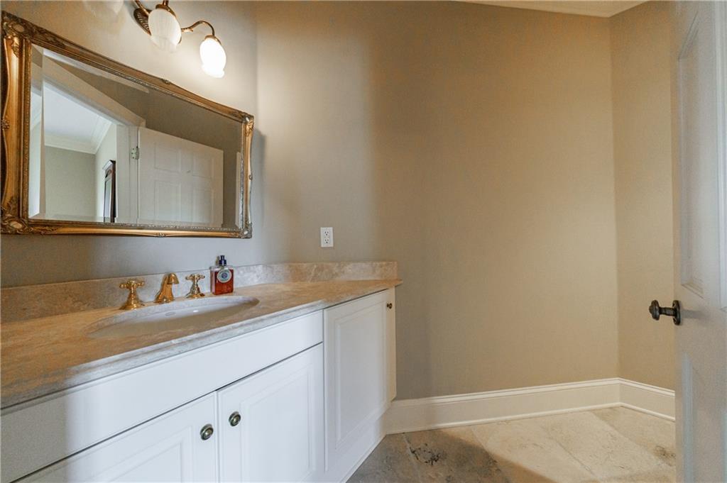 9390 Colonnade Trail Alpharetta, GA 30022 - Photo 59 of 122 a bathroom with a sink and a mirror