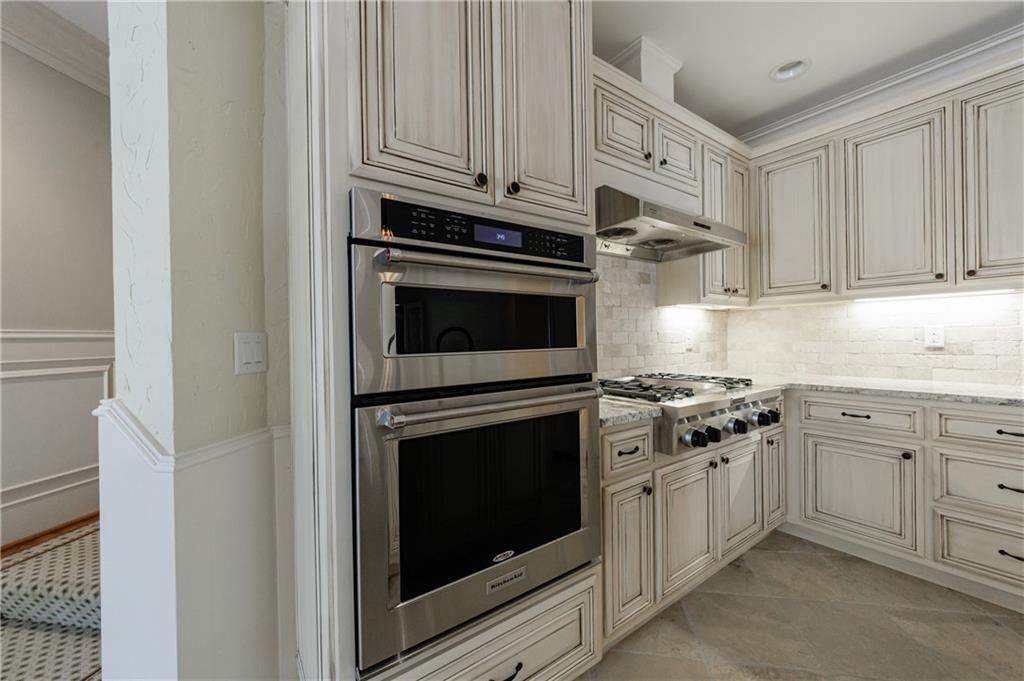 9390 Colonnade Trail Alpharetta, GA 30022 - Photo 76 of 122 a kitchen with stainless steel appliances granite countertop white cabinets a sink and dishwasher