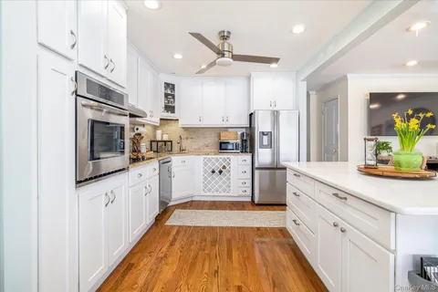 a kitchen with stainless steel appliances a refrigerator sink and microwave