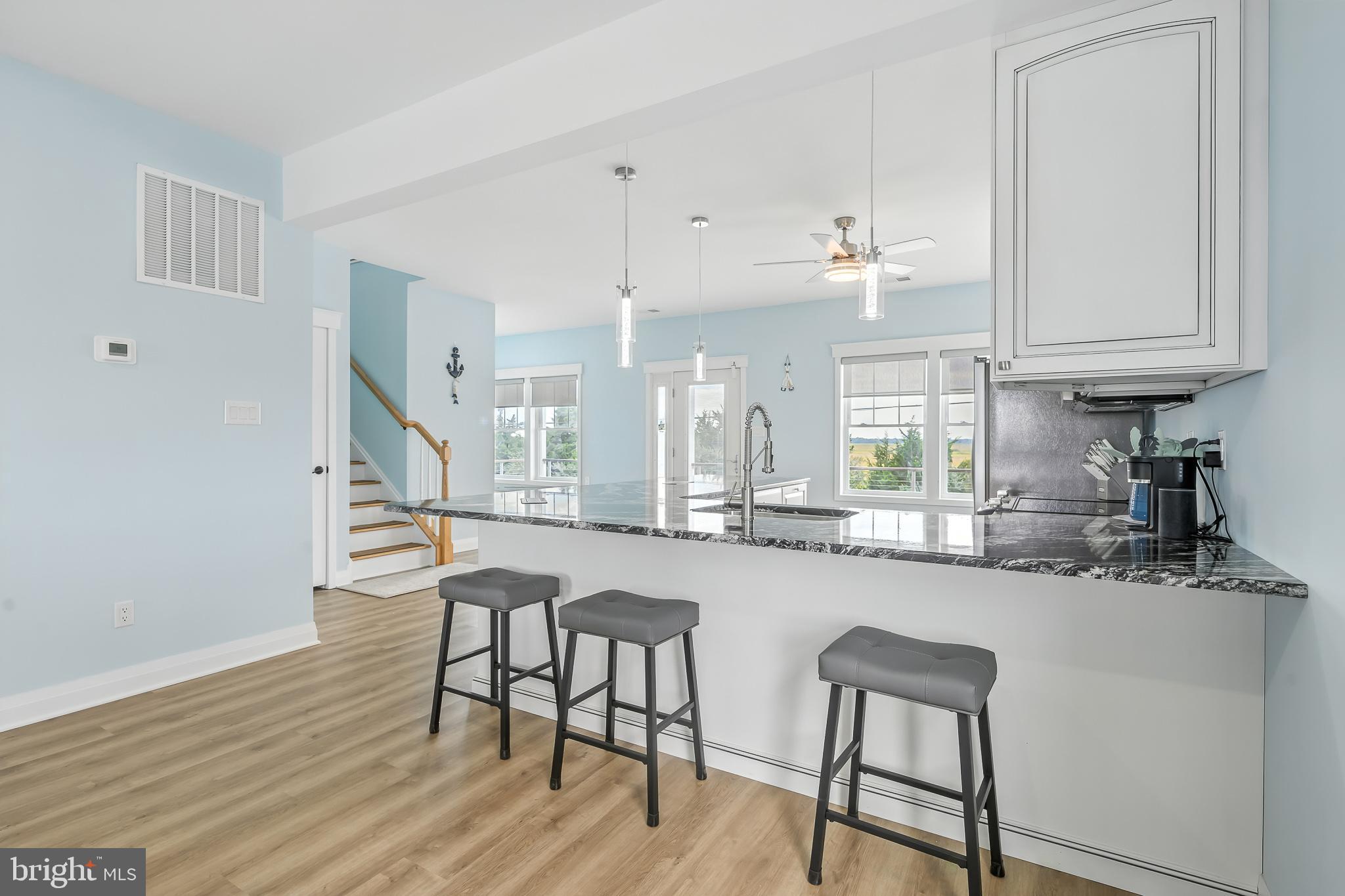 549 Bay Avenue Milford, DE 19963 - Photo 11 of 60 a kitchen with granite countertop white cabinets and chairs