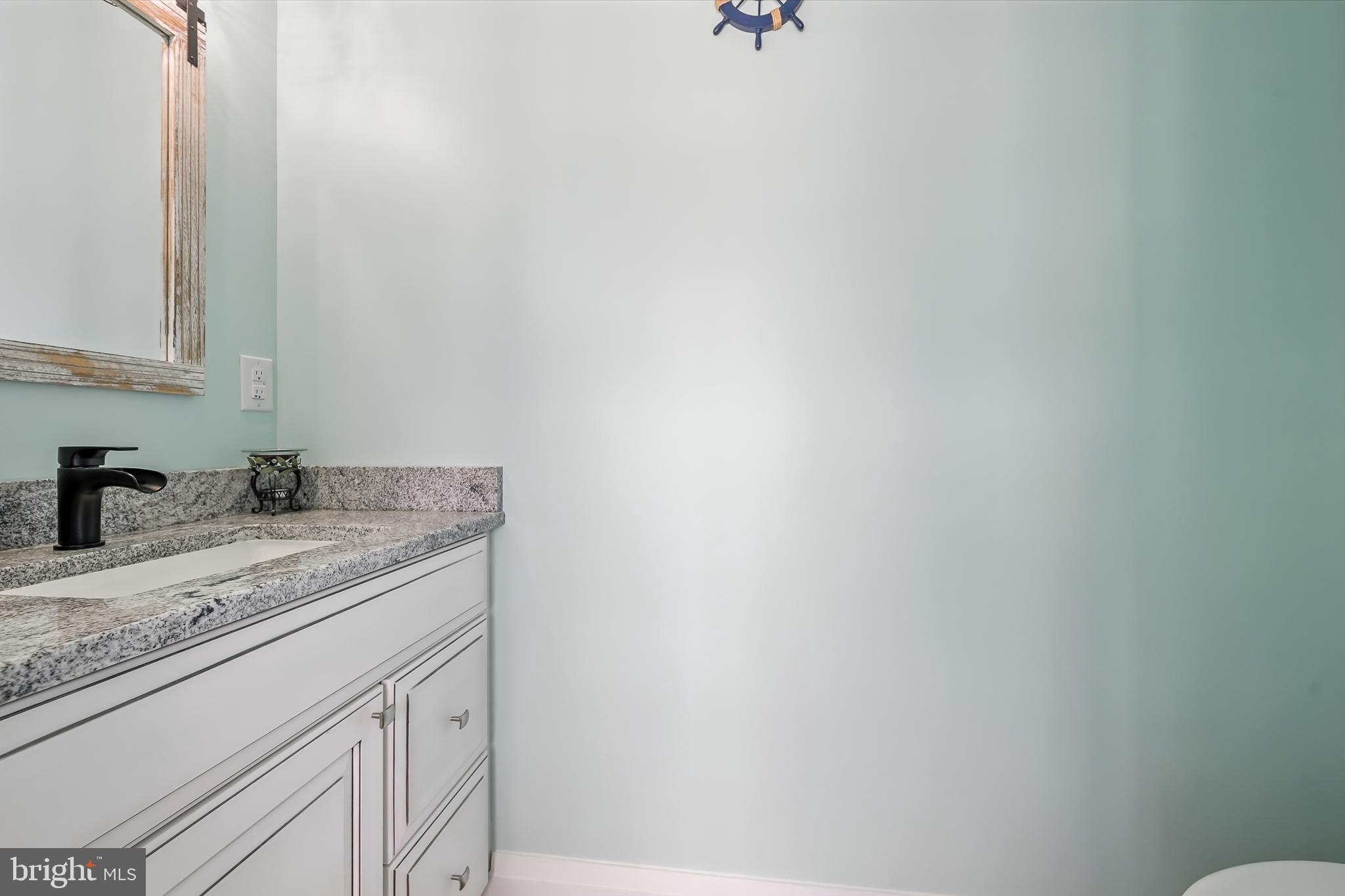 549 Bay Avenue Milford, DE 19963 - Photo 13 of 60 a bathroom with a granite countertop sink and vanity