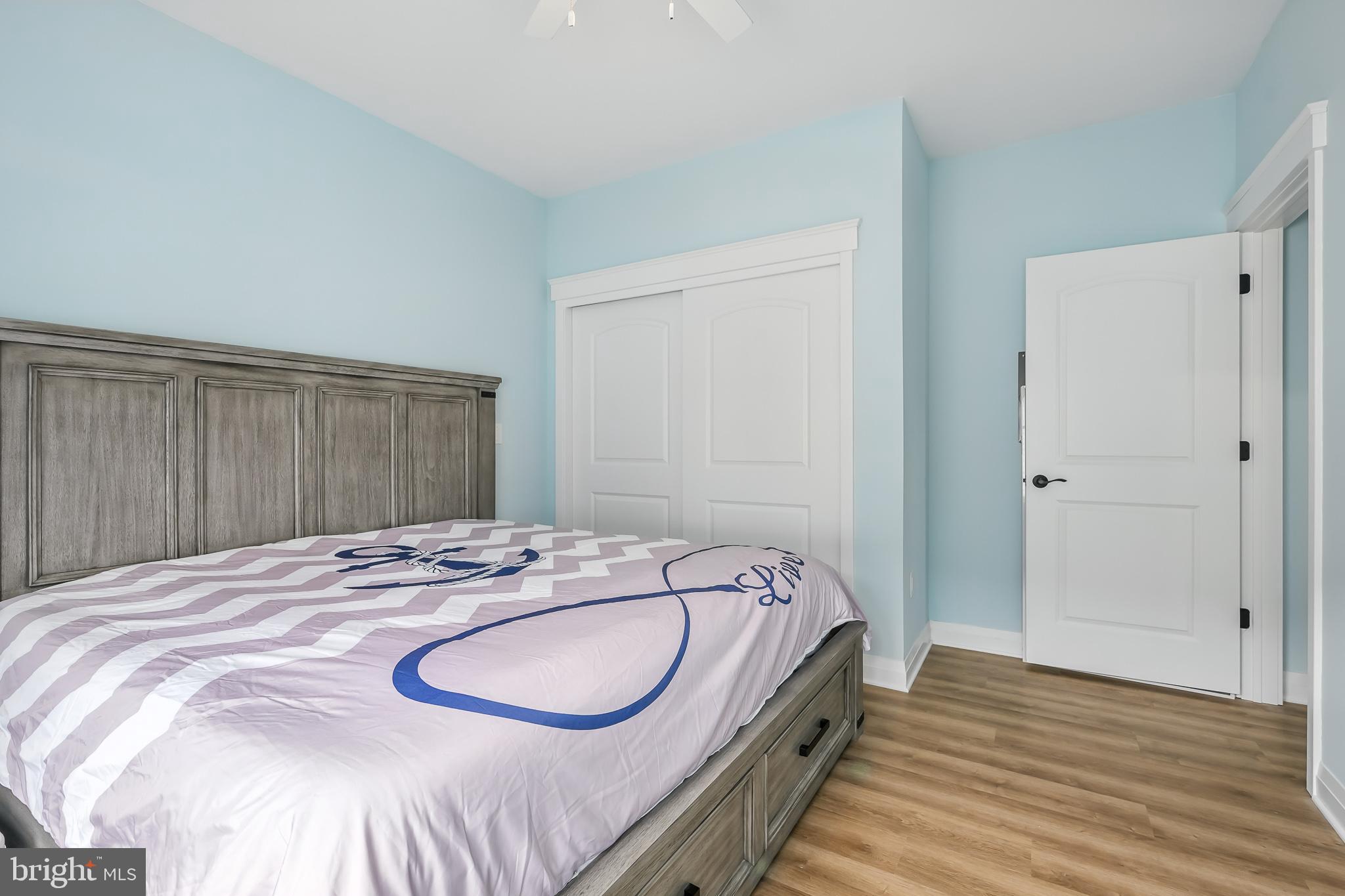 549 Bay Avenue Milford, DE 19963 - Photo 44 of 60 a bedroom with a bed and wooden floor