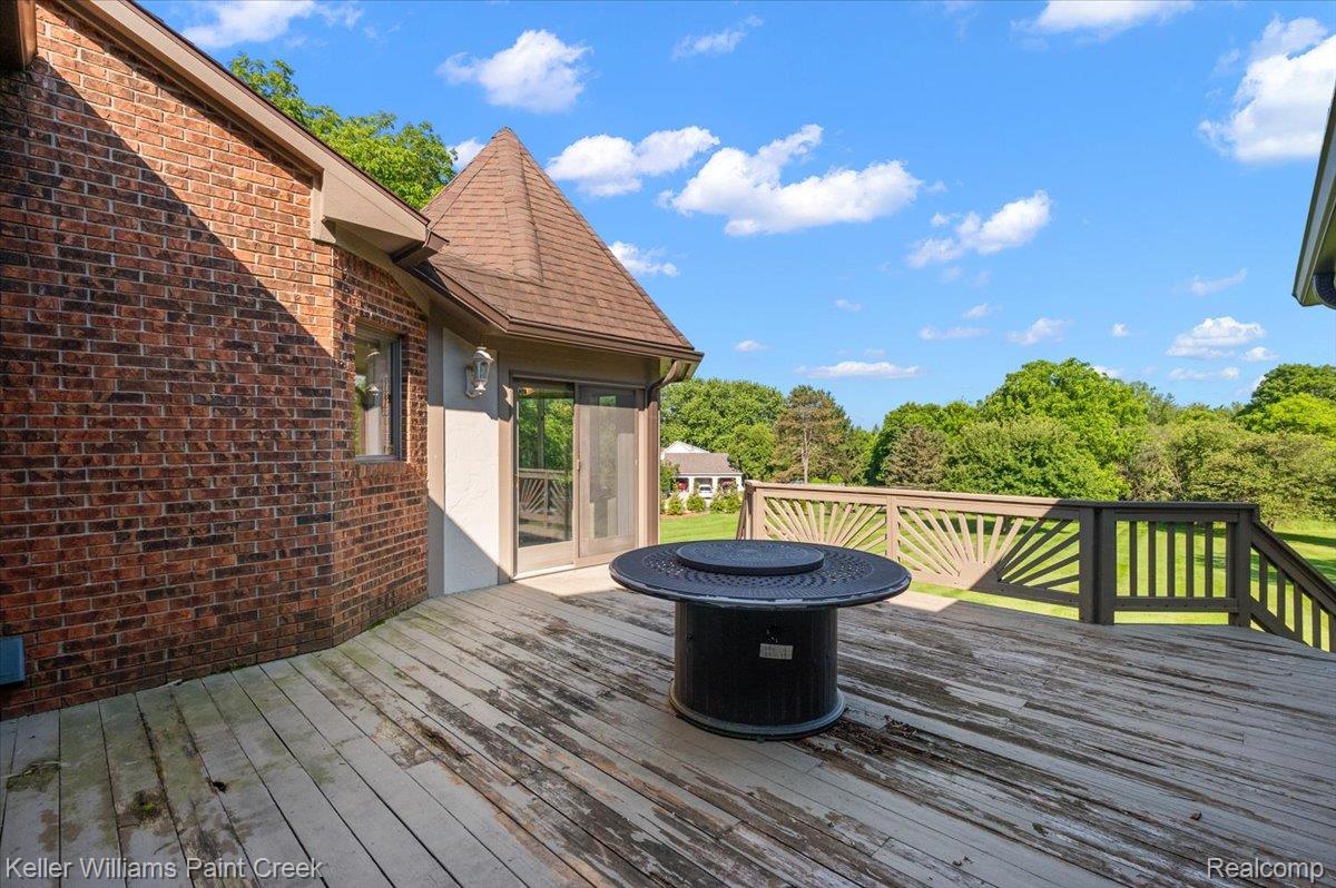 69069 Campground Road Romeo, MI 48065 - Photo 15 of 78 Expansive wood deck featuring a decorative railing and a dark circular outdoor table