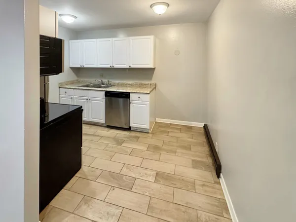 a kitchen with stainless steel appliances granite countertop a stove top oven a sink a counter top space and cabinets