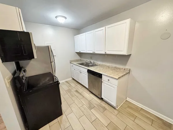 a kitchen with a sink and a stove