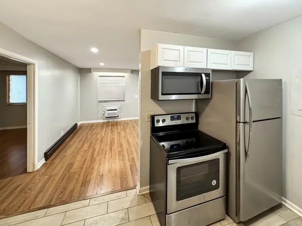 a kitchen with a refrigerator stove and microwave