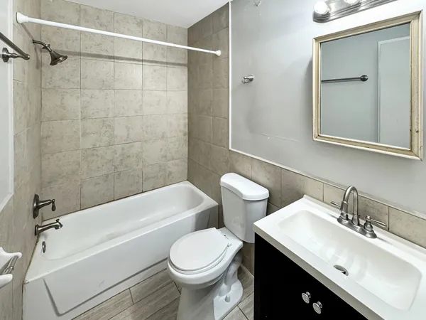 a bathroom with a sink toilet vanity and shower