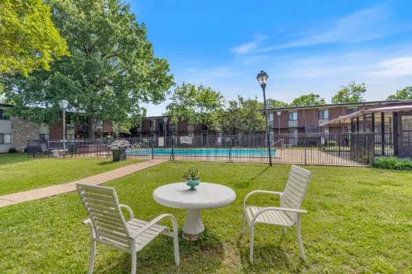 a swimming pool with outdoor seating and yard