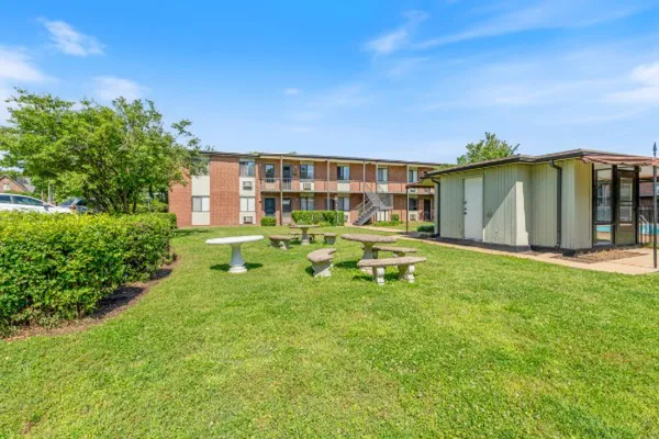 a backyard of a house with table and chairs