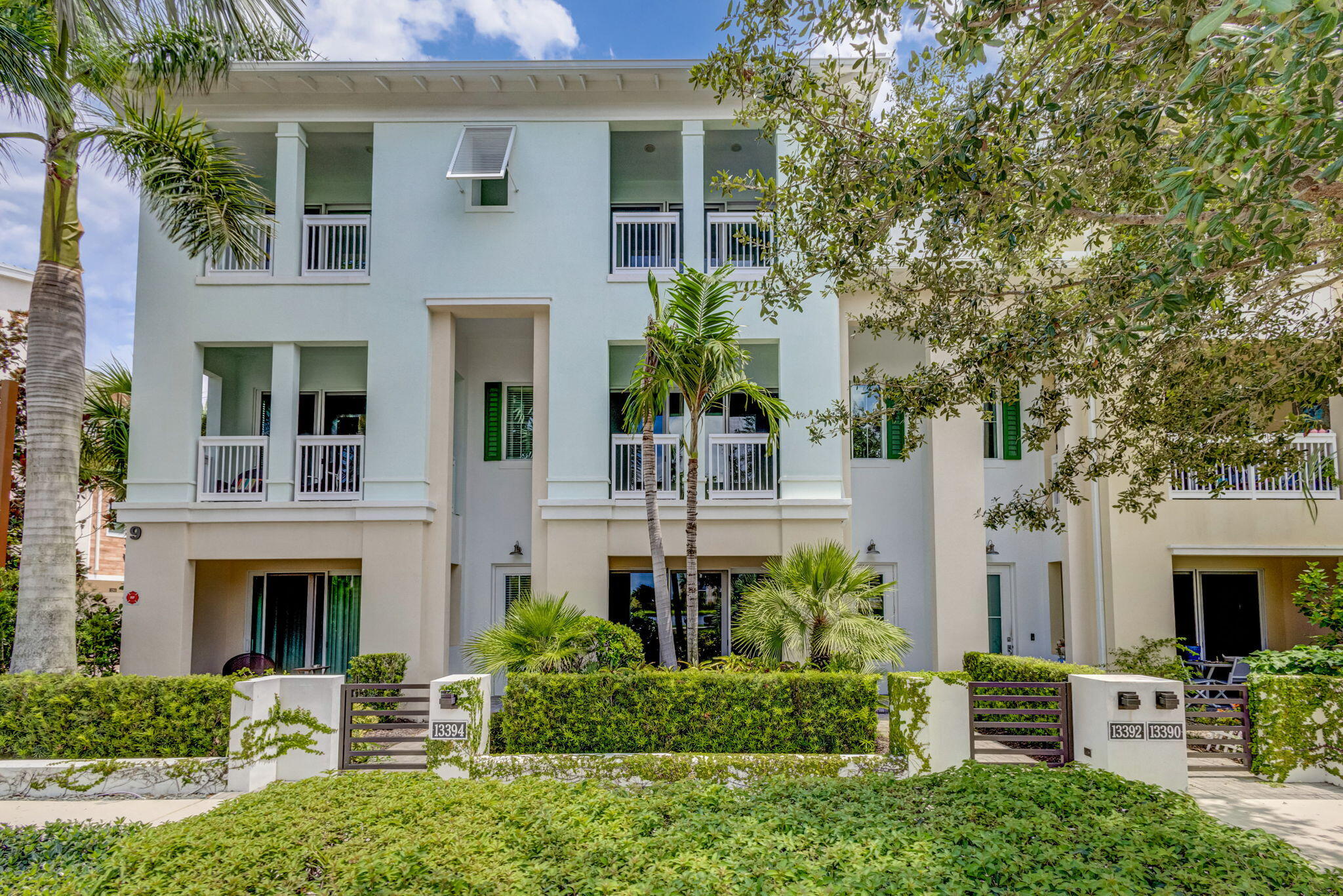 13392 Alton Road Palm Beach Gardens, FL 33418 - Photo 1 of 57 a front view of a house with a garden