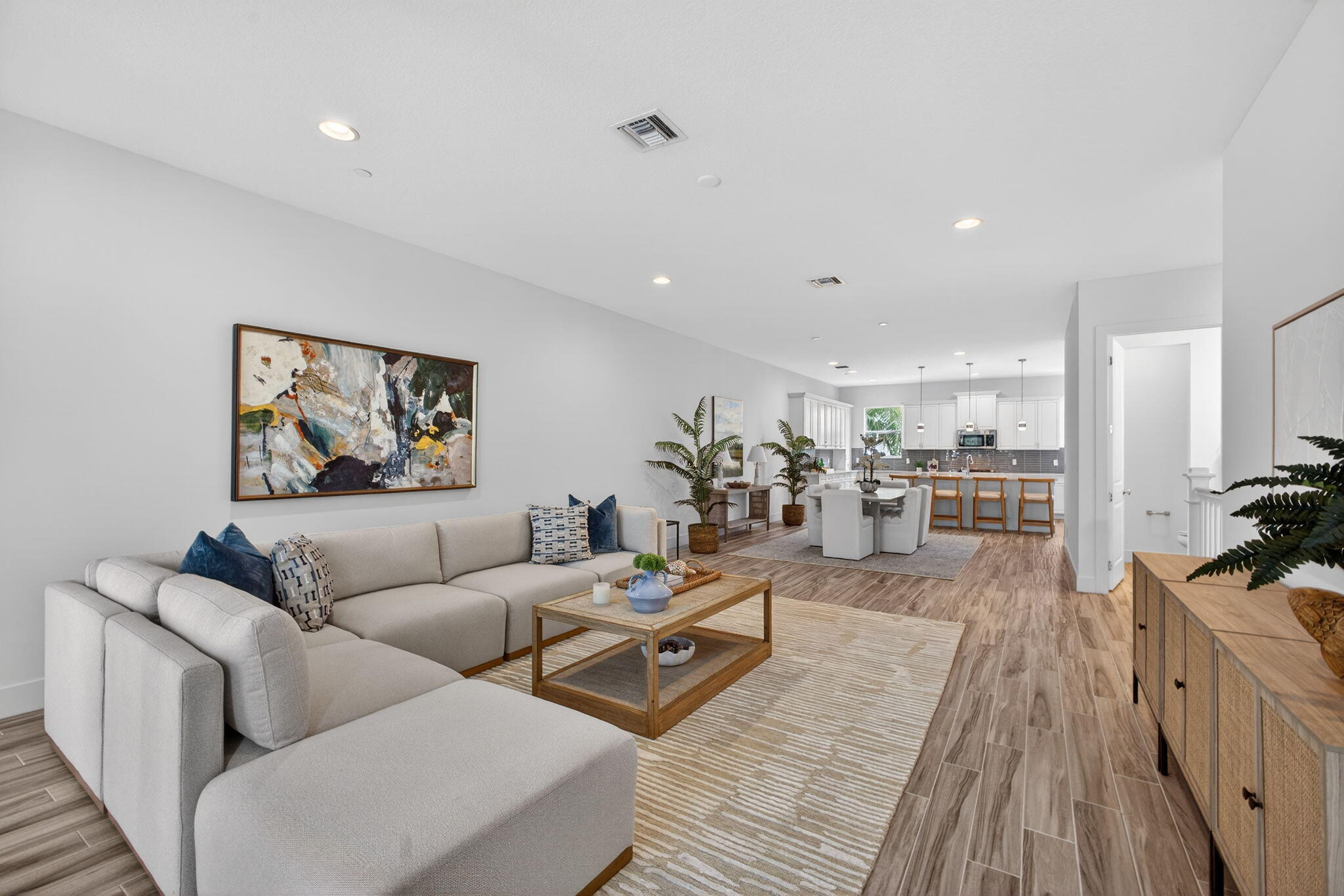 13392 Alton Road Palm Beach Gardens, FL 33418 - Photo 13 of 57 a living room with furniture kitchen view and a wooden floor