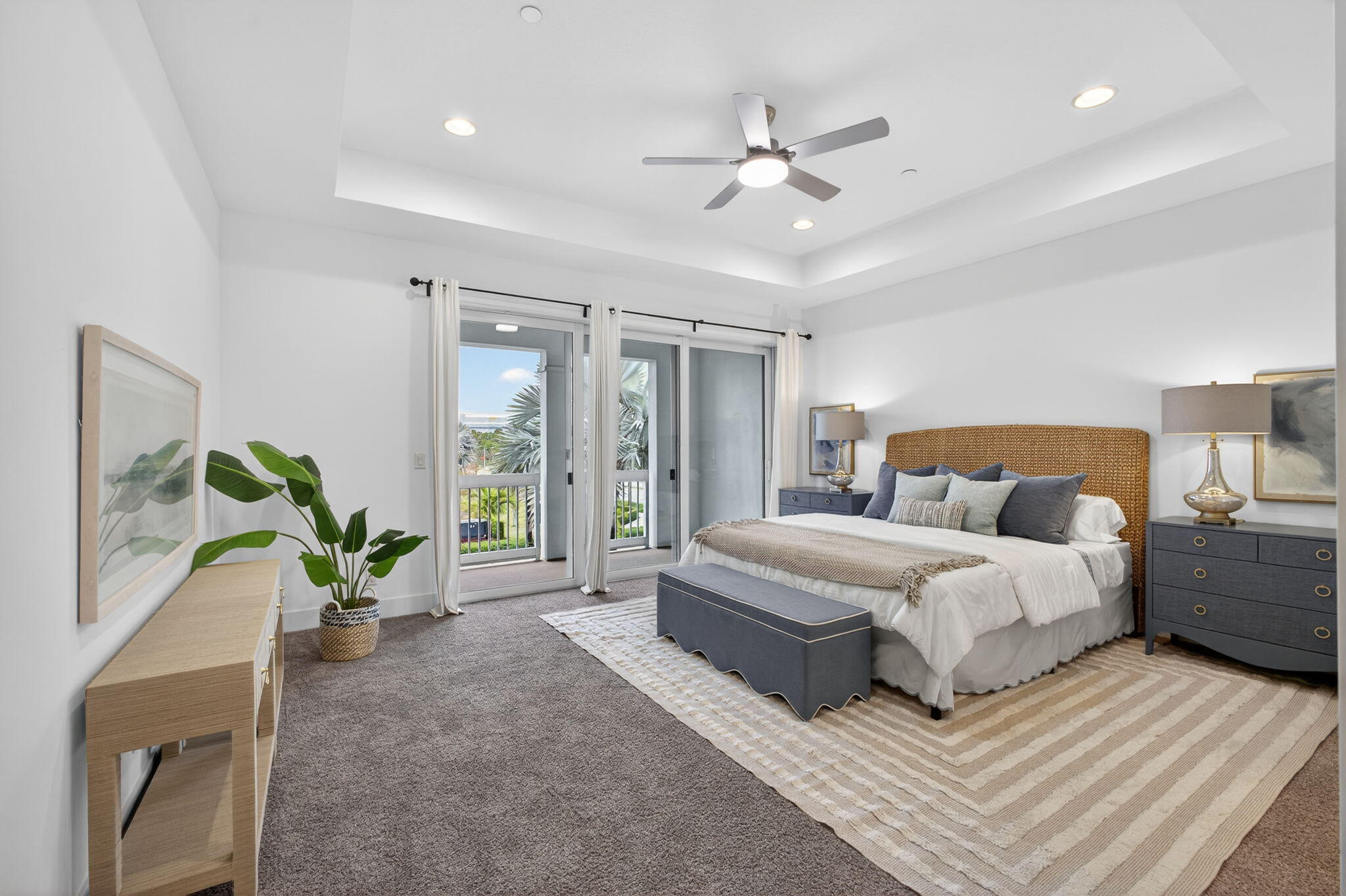 13392 Alton Road Palm Beach Gardens, FL 33418 - Photo 31 of 57 a spacious bedroom with a large bed and a chandelier