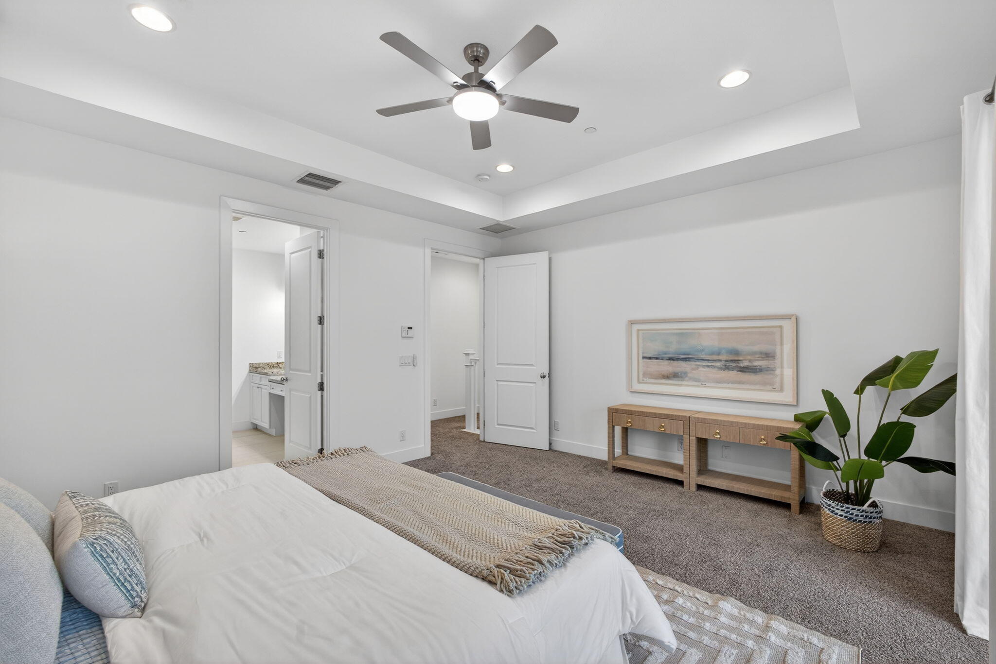 13392 Alton Road Palm Beach Gardens, FL 33418 - Photo 33 of 57 a spacious bedroom with a bed and a chandelier