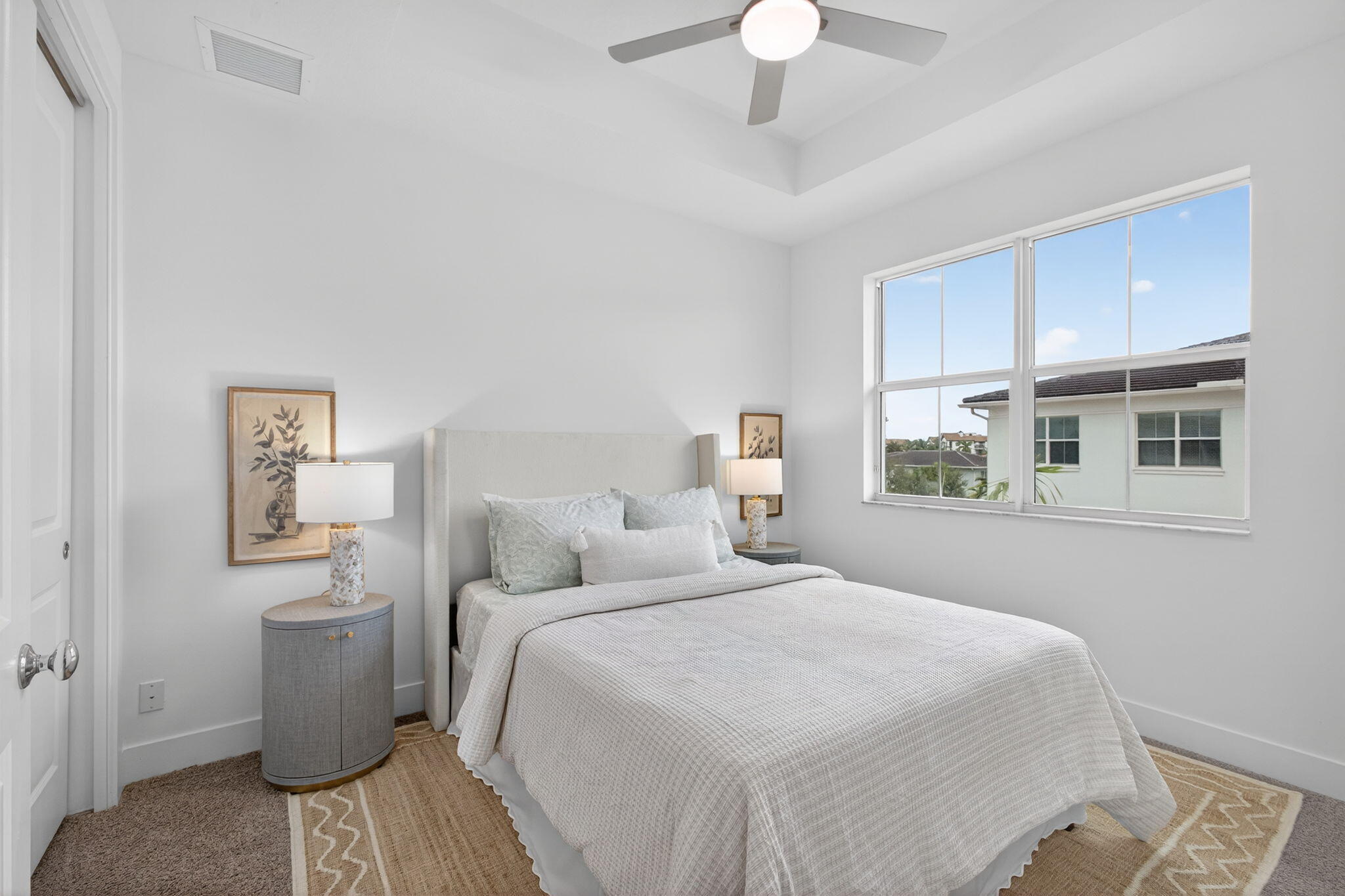 13392 Alton Road Palm Beach Gardens, FL 33418 - Photo 38 of 57 a bedroom with a bed and a chandelier
