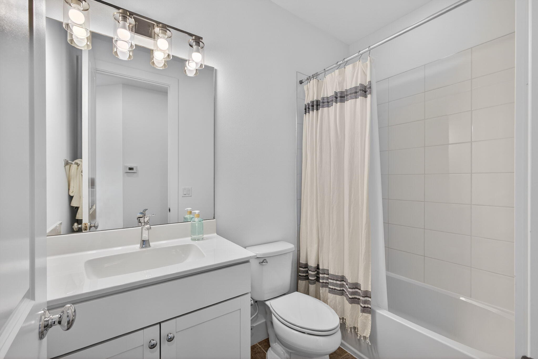 13392 Alton Road Palm Beach Gardens, FL 33418 - Photo 42 of 57 a bathroom with a sink a toilet and shower