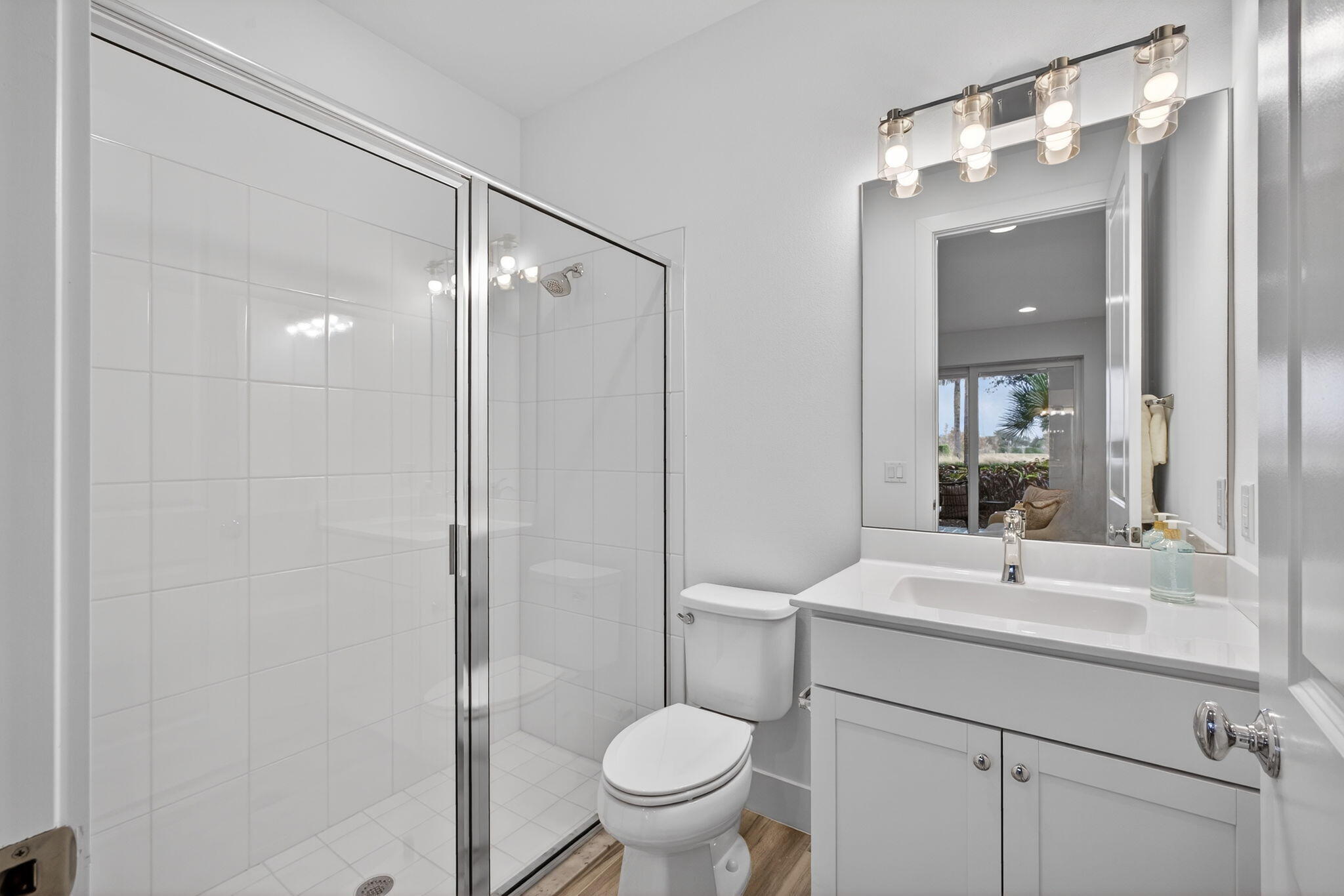 13392 Alton Road Palm Beach Gardens, FL 33418 - Photo 9 of 57 a bathroom with a toilet a sink and mirror