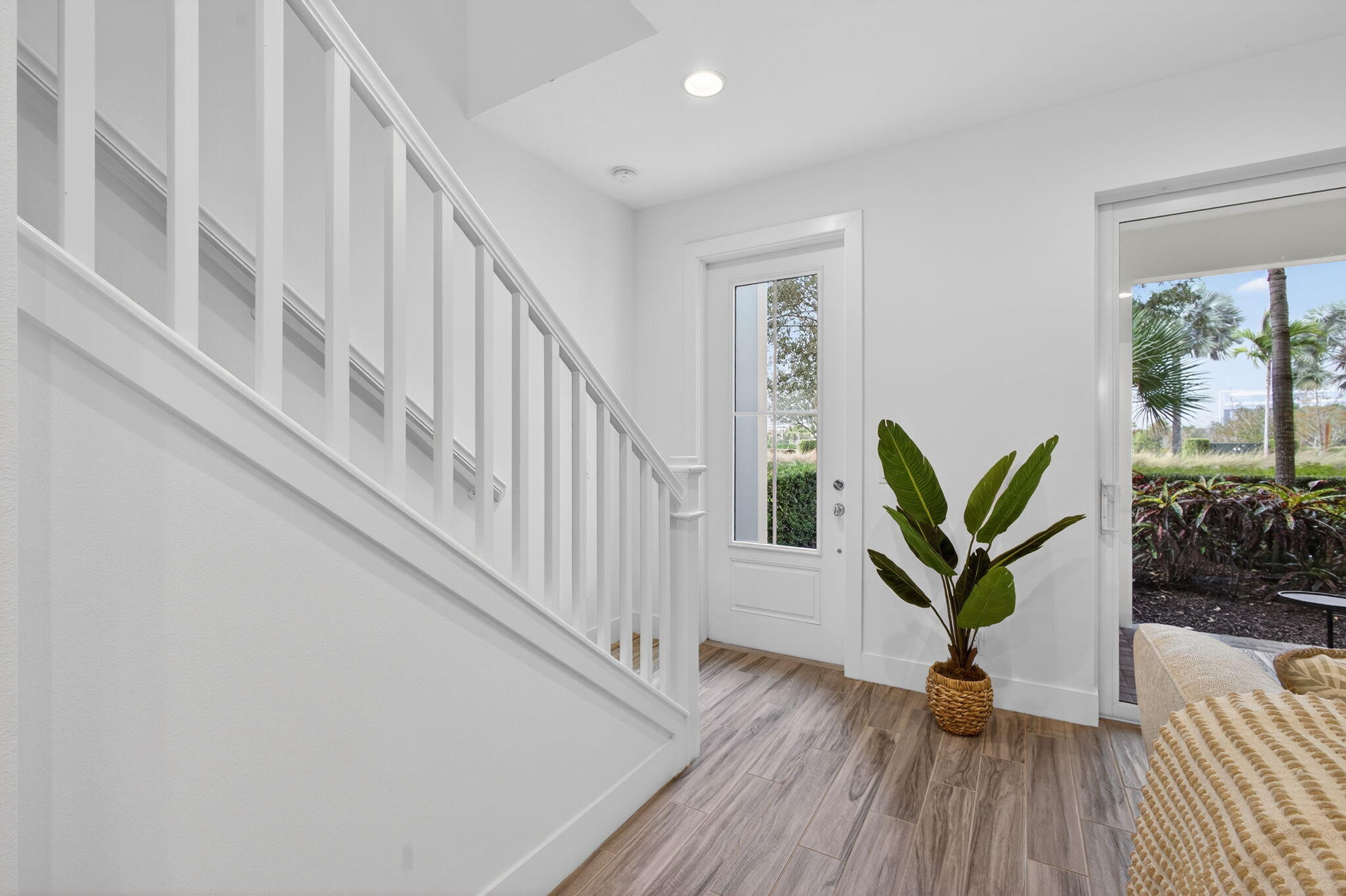 13392 Alton Road Palm Beach Gardens, FL 33418 - Photo 10 of 57 a view of staircase with wooden floor and a potted plant