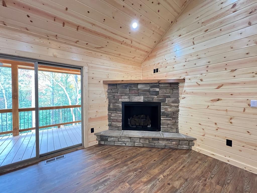 94 Ranger Trail Way Murphy, NC 28906 - Photo 9 of 25 a view of an empty room with wooden floor and a fireplace