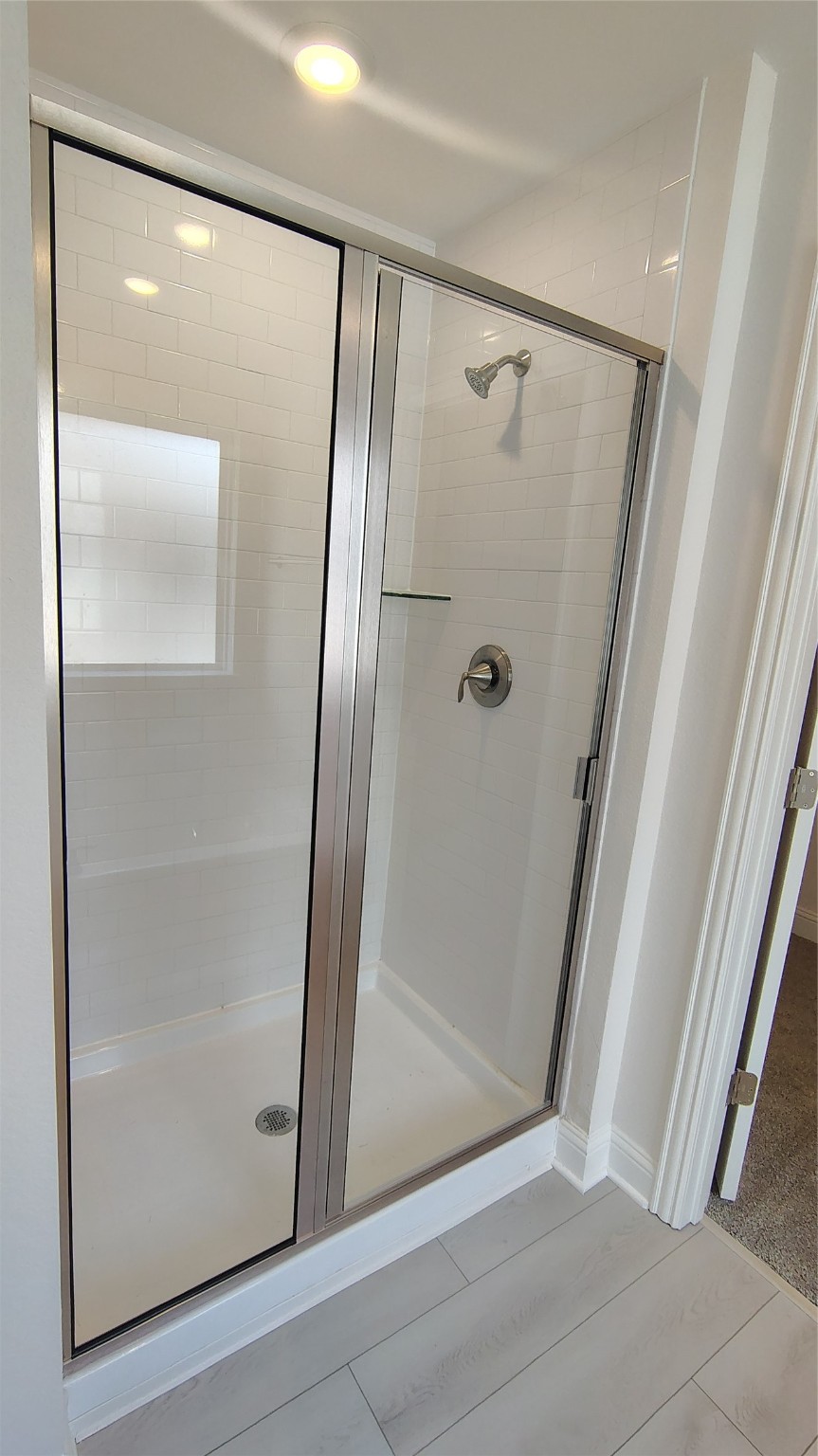 640 Greystone Lane Angleton, TX 77515 - Photo 11 of 17 a bathroom with a glass shower door and mirror