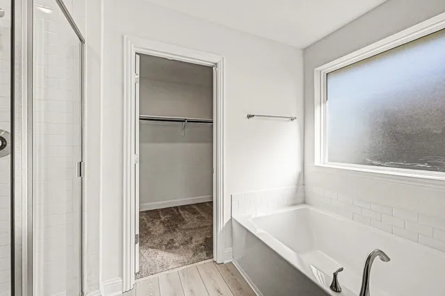 a bathroom with a tub and shower
