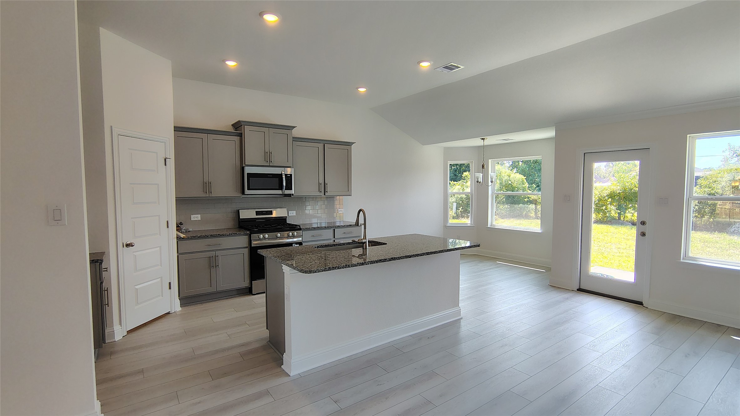 640 Greystone Lane Angleton, TX 77515 - Photo 5 of 17 a kitchen with granite countertop a sink cabinets and stainless steel appliances