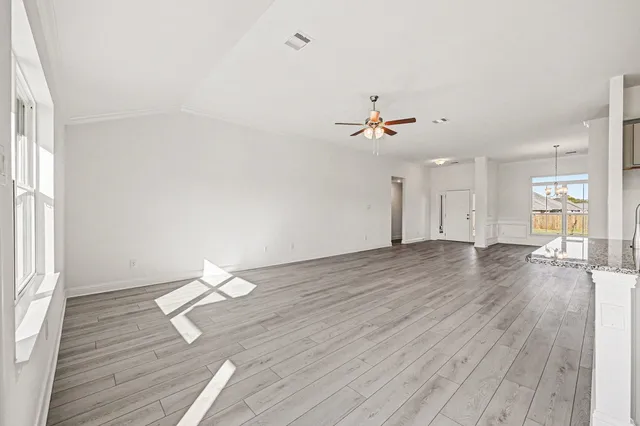 wooden floor in an empty room with a window