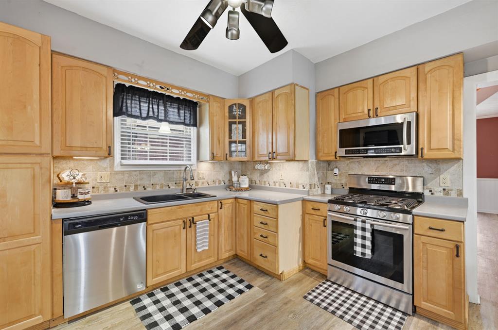 144 Davis Avenue McKees Rocks, PA 15136 - Photo 28 of 50 a kitchen with stainless steel appliances a stove a sink and a microwave