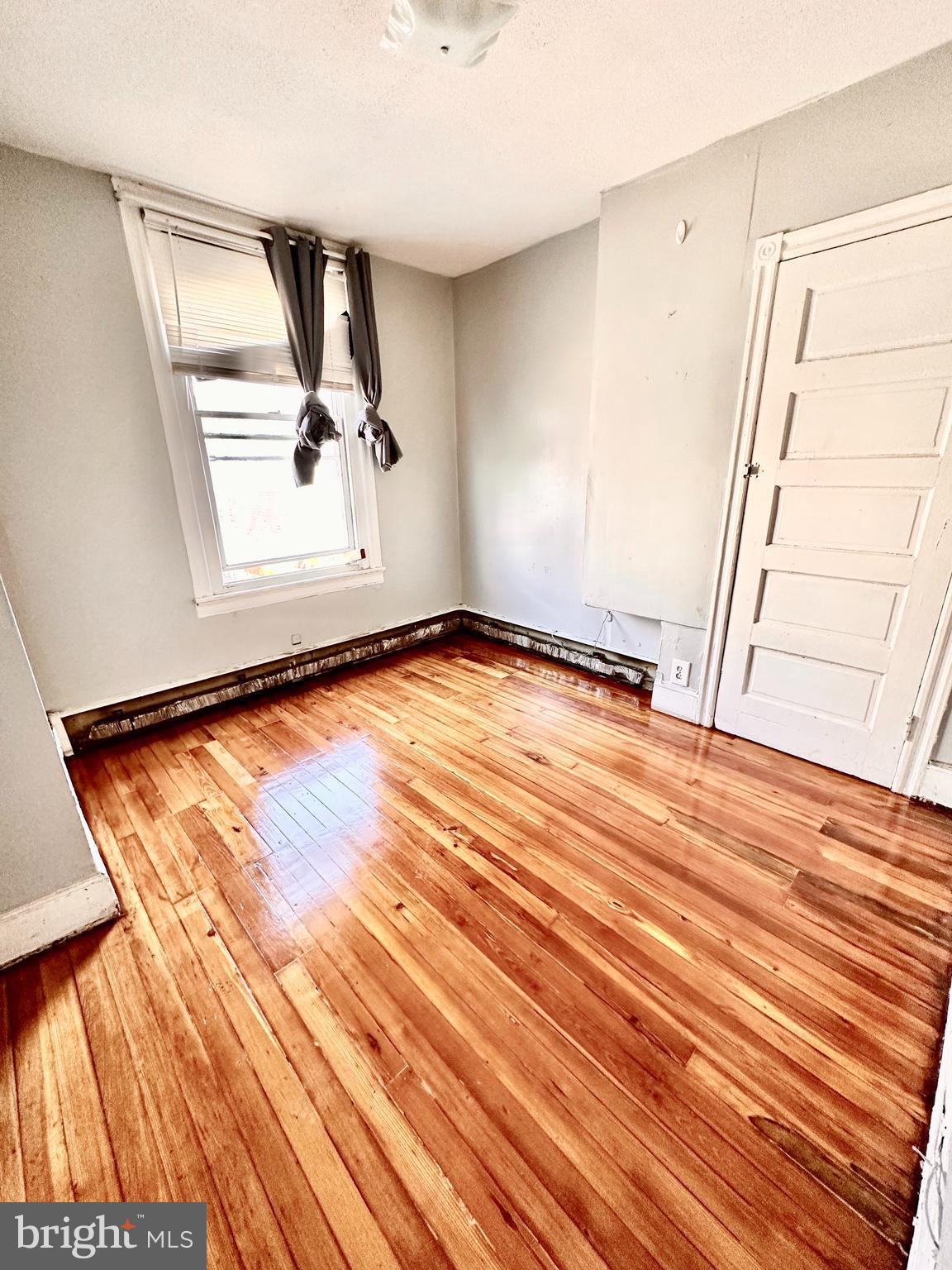 3223 North Bambrey Street Philadelphia, PA 19129 - Photo 12 of 14 a view of an empty room with wooden floor and a window