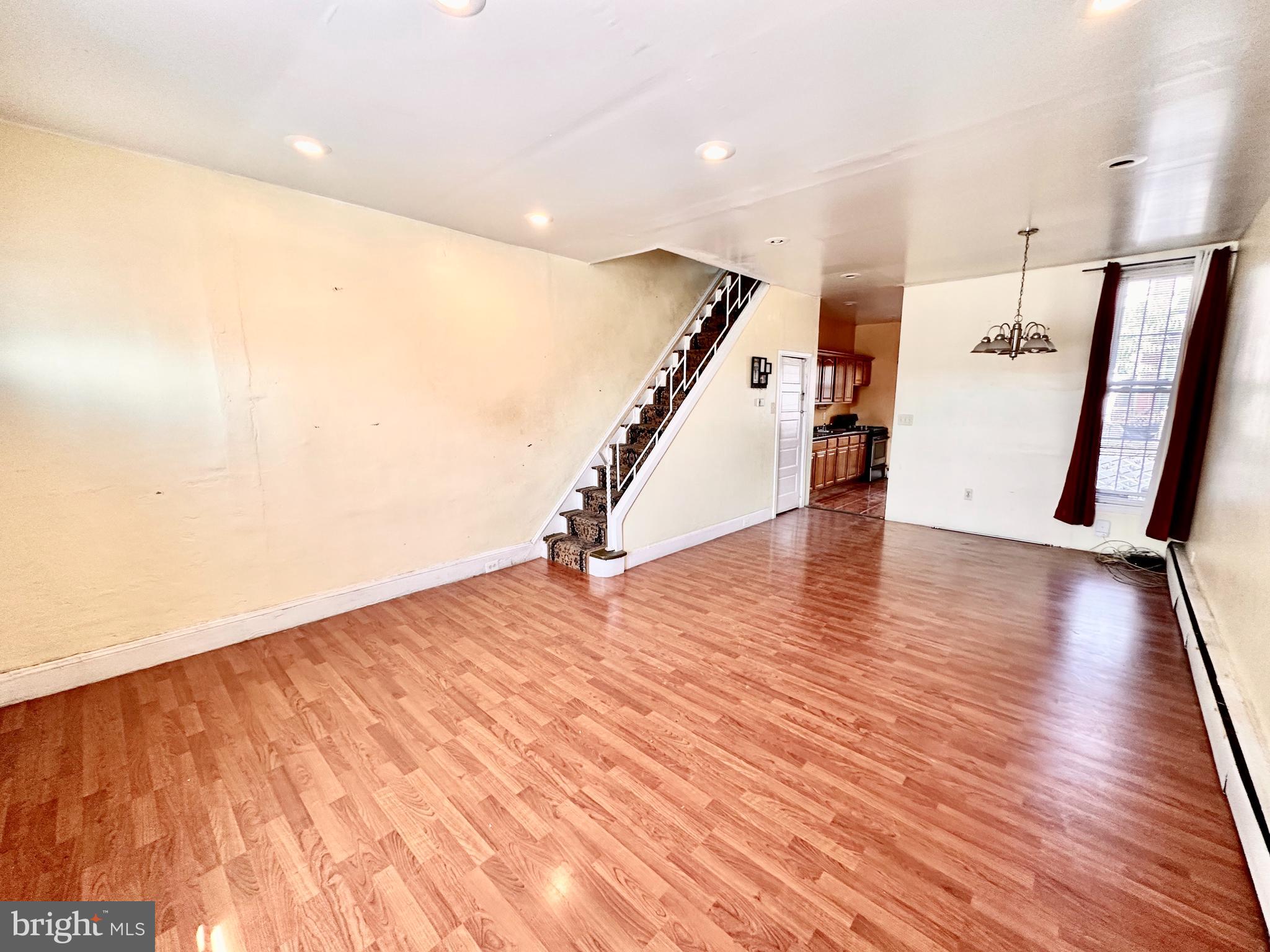 3223 North Bambrey Street Philadelphia, PA 19129 - Photo 4 of 14 a view of an empty room with wooden floor and stairs