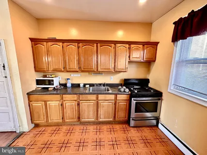 a kitchen with stainless steel appliances granite countertop a stove and a sink