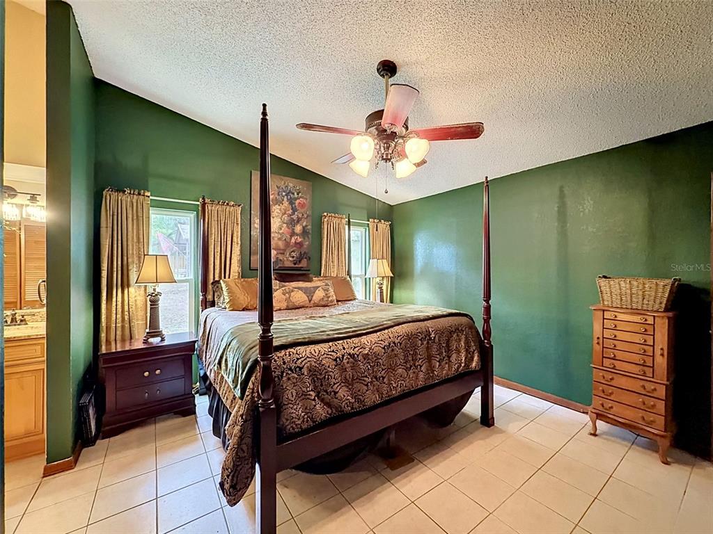 7111 Ricker Avenue Webster, FL 33597 - Photo 19 of 41 a bedroom with a bed and a chandelier