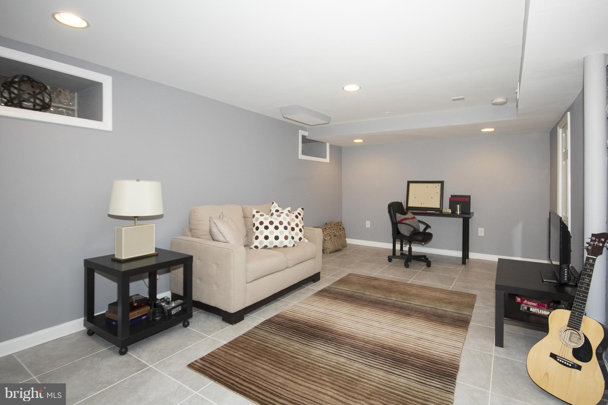 4033 Deepwood Road Baltimore, MD 21218 - Photo 22 of 30 a living room with furniture and a potted plant on a table