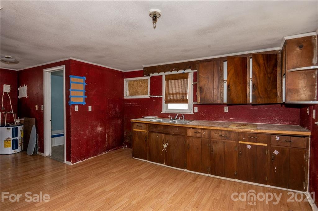 419 Incinerator Road Clyde, NC 28721 - Photo 2 of 17 a spacious bathroom with a granite countertop sink and a mirror