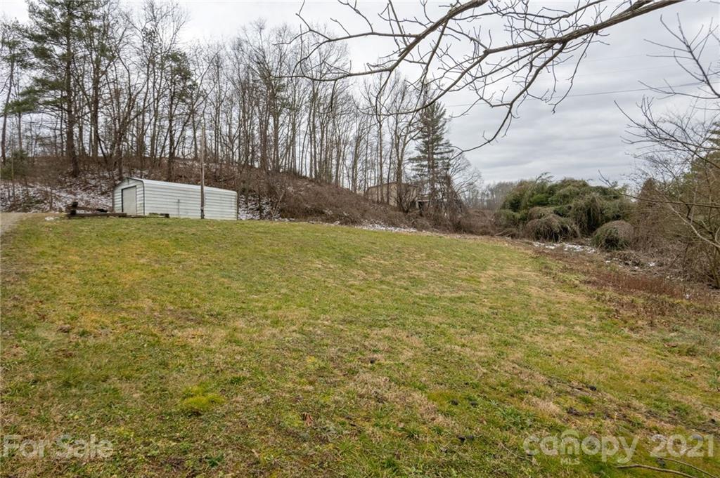 419 Incinerator Road Clyde, NC 28721 - Photo 15 of 17 a backyard of a house with lots of green space