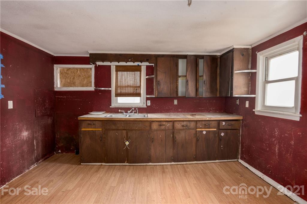 419 Incinerator Road Clyde, NC 28721 - Photo 3 of 17 a room with granite countertop cabinets and window